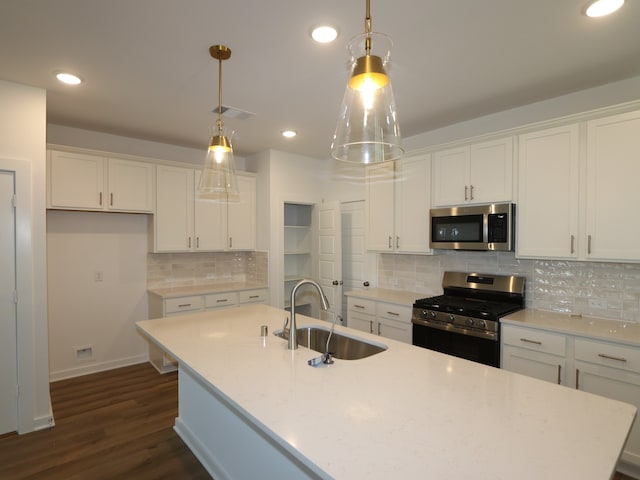 8026 Kay Harbor Dr, Cypress, TX 77433 - kitchen with stainless steel appliances, a sink, an island with sink, white cabinetry, and recessed lighting
