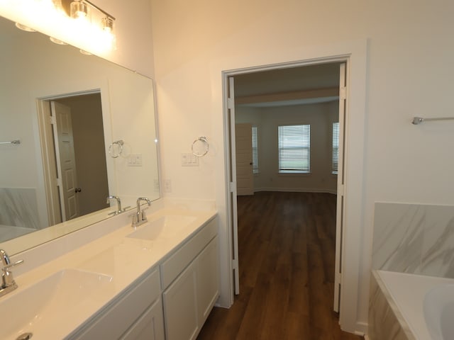 8026 Kay Harbor Dr, Cypress, TX 77433 - bathroom with wood finished floors, double vanity, and a tub to relax in