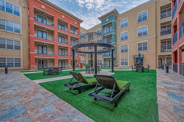 surrounding community featuring a gazebo and a lawn