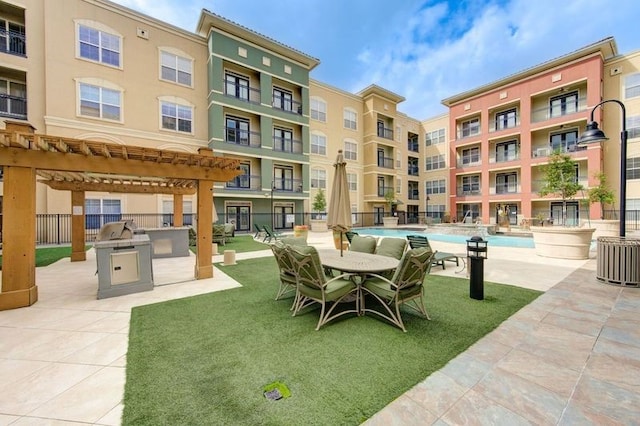 view of property's community with a pool, a pergola, and a lawn