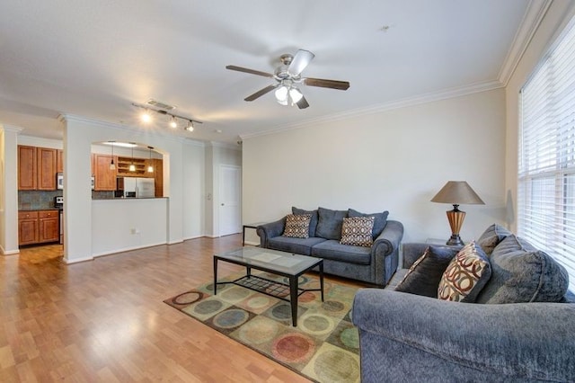 living room featuring hardwood / wood-style floors, crown molding, and ceiling fan