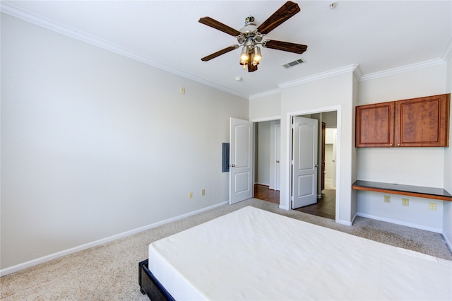 unfurnished bedroom featuring crown molding, ceiling fan, and carpet flooring