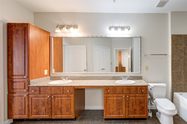 bathroom featuring vanity, a bath, and toilet