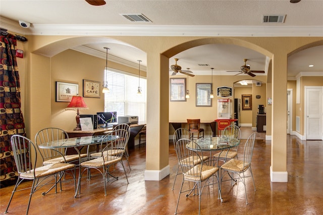 dining space with ceiling fan, ornamental molding, and a textured ceiling