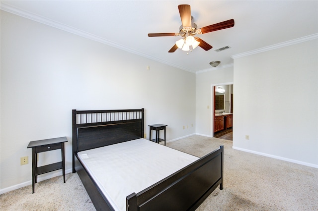 carpeted bedroom with ensuite bath, ornamental molding, and ceiling fan