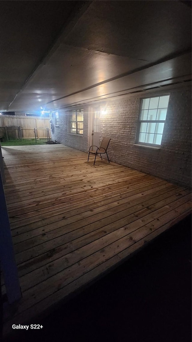 interior space featuring hardwood / wood-style floors and brick wall