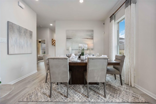 dining area with light hardwood / wood-style floors