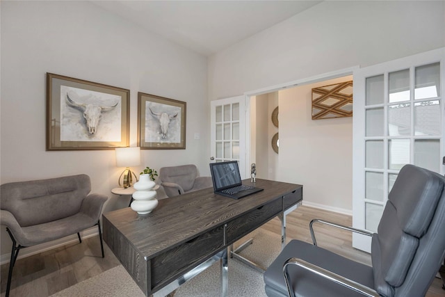 office featuring hardwood / wood-style flooring and french doors