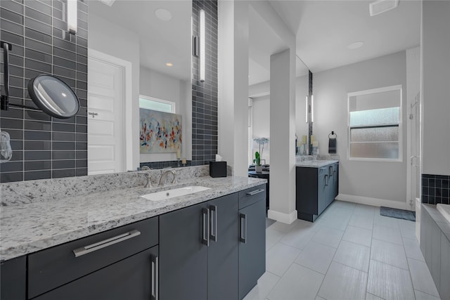 bathroom featuring vanity, tile patterned flooring, and plenty of natural light