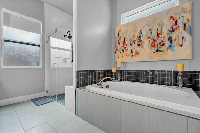 bathroom featuring tile patterned flooring and independent shower and bath