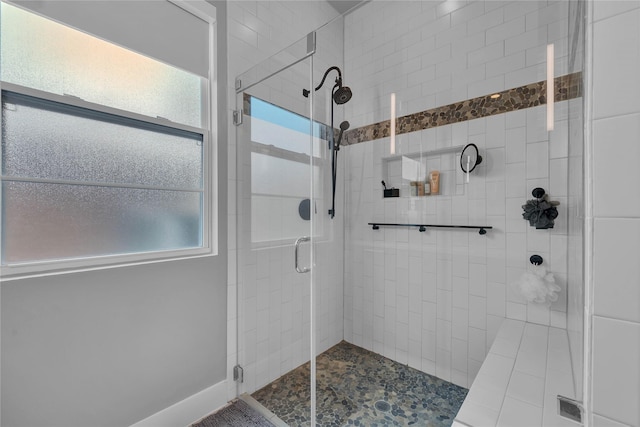 bathroom featuring an enclosed shower and a healthy amount of sunlight