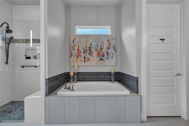 bathroom featuring tile patterned floors and independent shower and bath