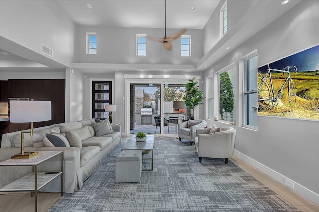 living room featuring wood-type flooring and a high ceiling