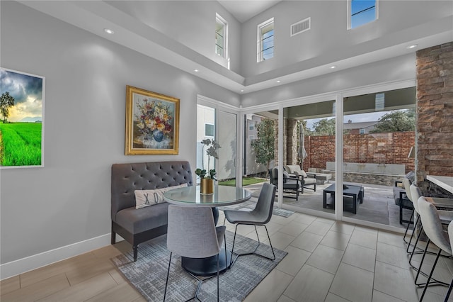 dining room with a towering ceiling