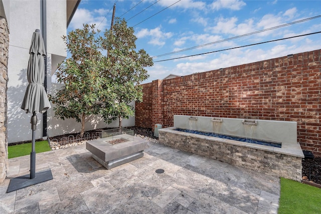 view of patio / terrace featuring an outdoor fire pit