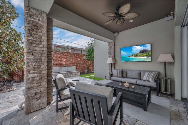 view of patio / terrace with an outdoor living space and ceiling fan