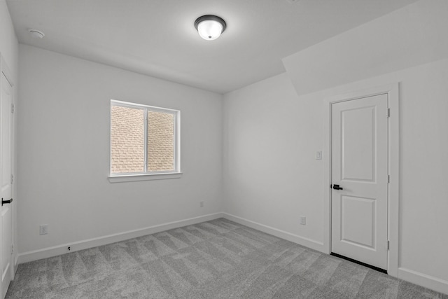 unfurnished room featuring light colored carpet