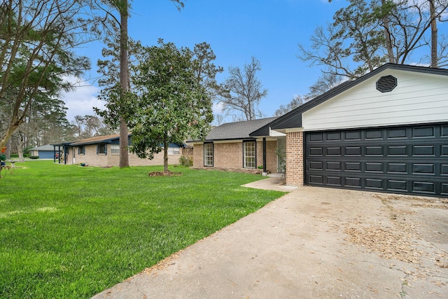 ranch-style house with concrete driveway, brick siding, an attached garage, and a front lawn