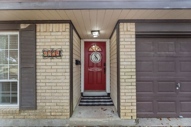 view of exterior entry with a garage