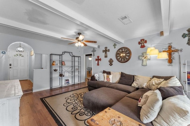 living room featuring beamed ceiling, ceiling fan, and dark hardwood / wood-style flooring