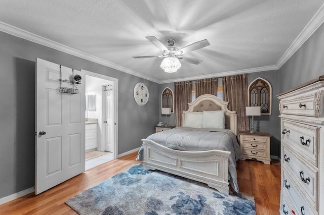 bedroom with light hardwood / wood-style flooring, ornamental molding, ceiling fan, and ensuite bathroom