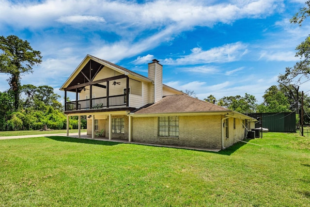 back of house with a yard, ceiling fan, and a patio area