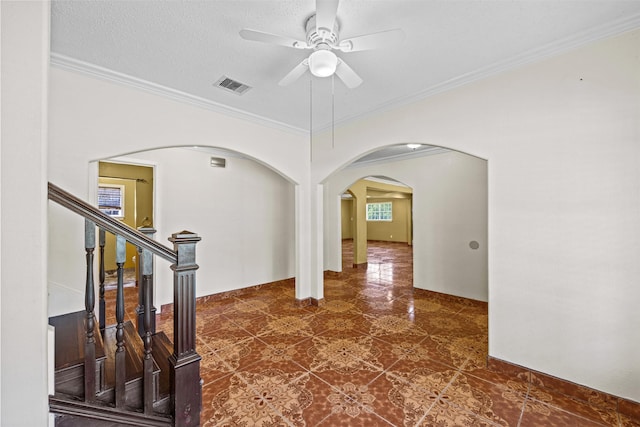 interior space featuring crown molding, a textured ceiling, and ceiling fan