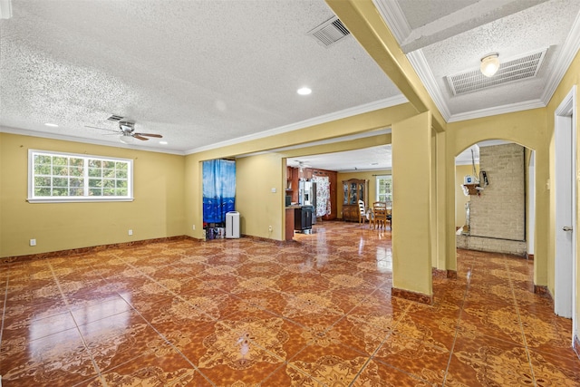 entryway featuring ceiling fan, crown molding, and a textured ceiling