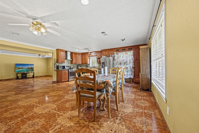 dining room featuring crown molding, a textured ceiling, and ceiling fan