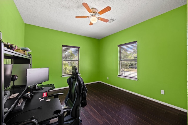 office with dark wood-type flooring, a textured ceiling, and ceiling fan