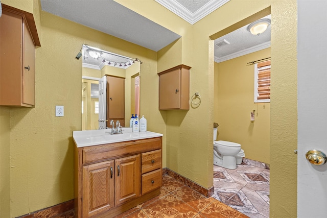 bathroom with tile patterned flooring, vanity, toilet, crown molding, and a textured ceiling