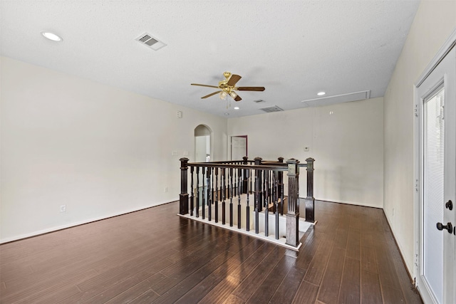 unfurnished room with dark hardwood / wood-style floors and ceiling fan