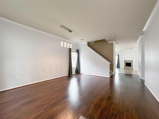 unfurnished living room featuring crown molding and dark hardwood / wood-style flooring