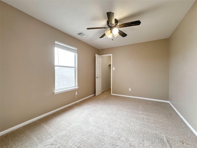 carpeted empty room featuring ceiling fan