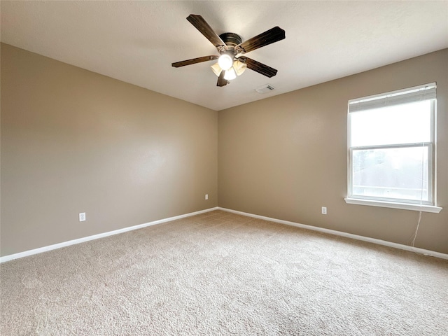 carpeted spare room featuring ceiling fan