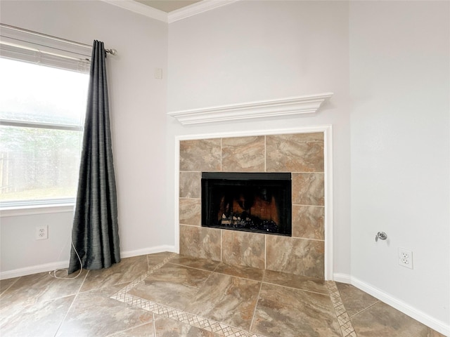 interior details with ornamental molding and a tile fireplace