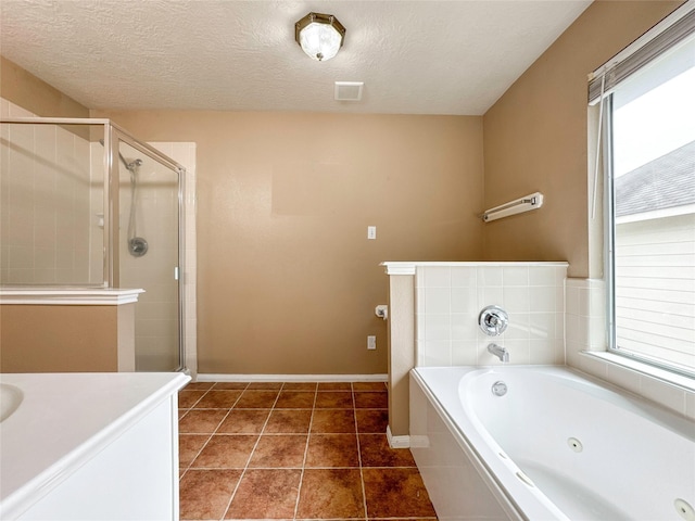 bathroom featuring vanity, tile patterned floors, shower with separate bathtub, and a textured ceiling
