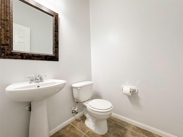 bathroom featuring sink, tile patterned floors, and toilet