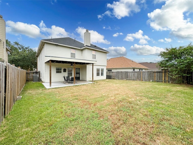 rear view of house featuring central AC, a lawn, and a patio area