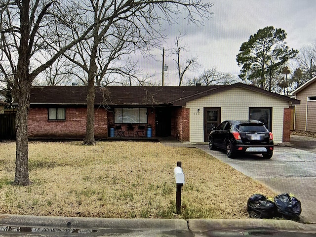 ranch-style house featuring a garage and a front yard