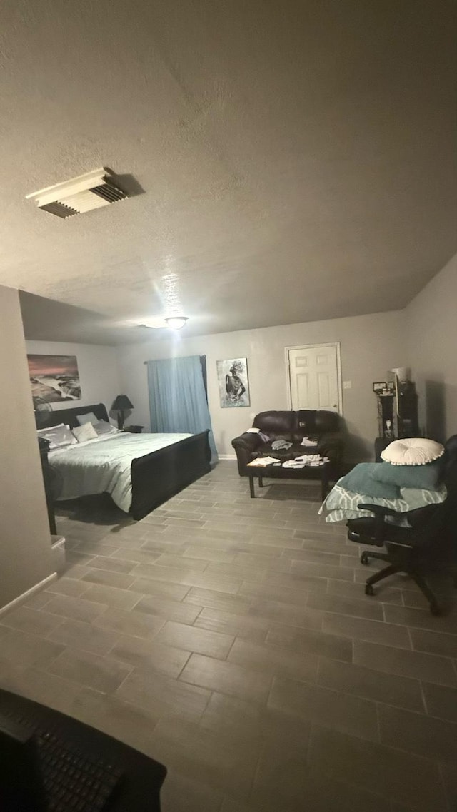 bedroom with visible vents and a textured ceiling