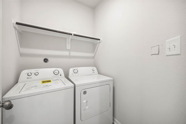 clothes washing area featuring laundry area and washing machine and clothes dryer