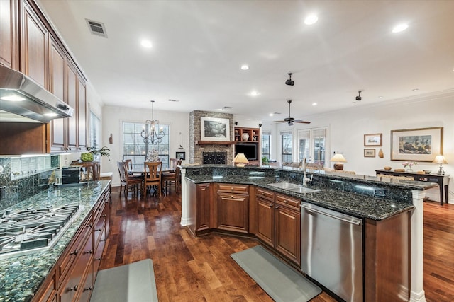 kitchen featuring dark wood-style flooring, a sink, visible vents, open floor plan, and appliances with stainless steel finishes