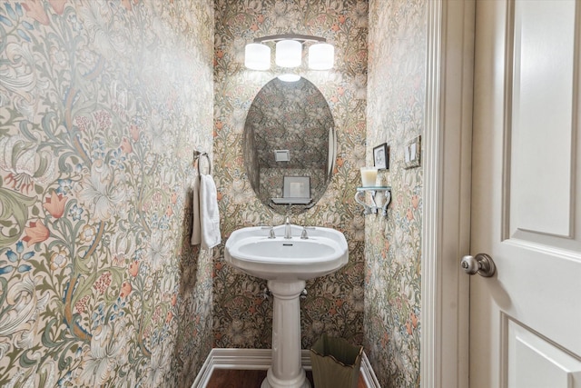 bathroom with wallpapered walls