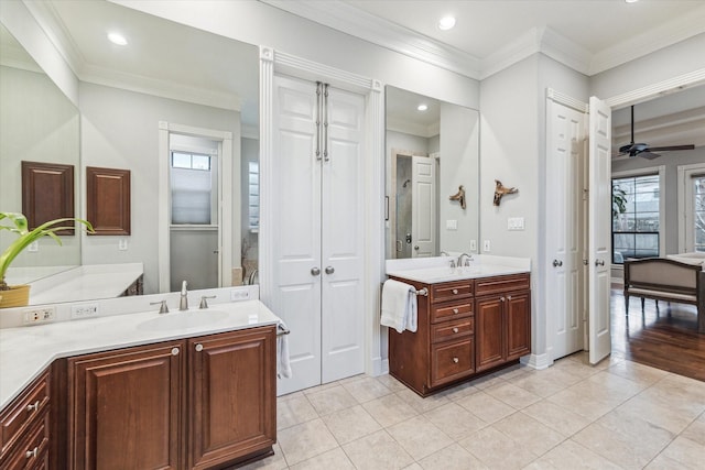 bathroom with tile patterned flooring, ornamental molding, and a sink