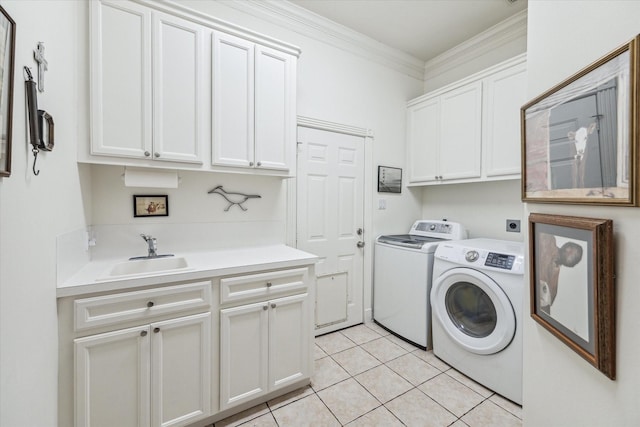 clothes washing area with washing machine and clothes dryer, light tile patterned floors, cabinet space, ornamental molding, and a sink