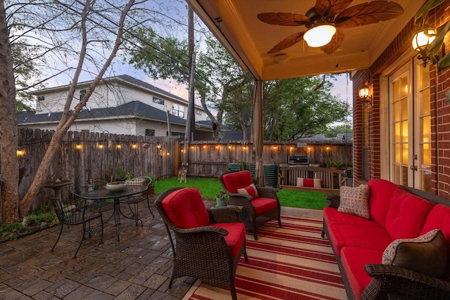 view of patio featuring ceiling fan, a fenced backyard, an outdoor hangout area, french doors, and outdoor dining space