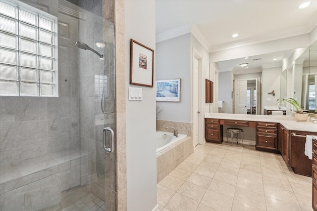 bathroom with a stall shower, ornamental molding, a bath, and vanity