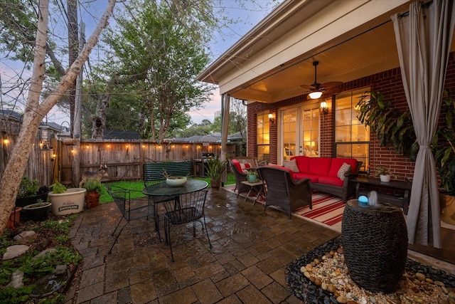 view of patio / terrace featuring outdoor dining area, ceiling fan, fence, and an outdoor living space