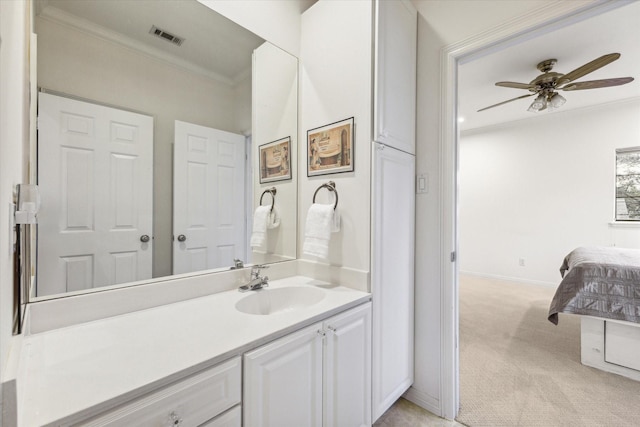 bathroom with crown molding, visible vents, a ceiling fan, vanity, and baseboards